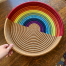Handmade rainbow woven tray basket by Ange Muhorakeye
